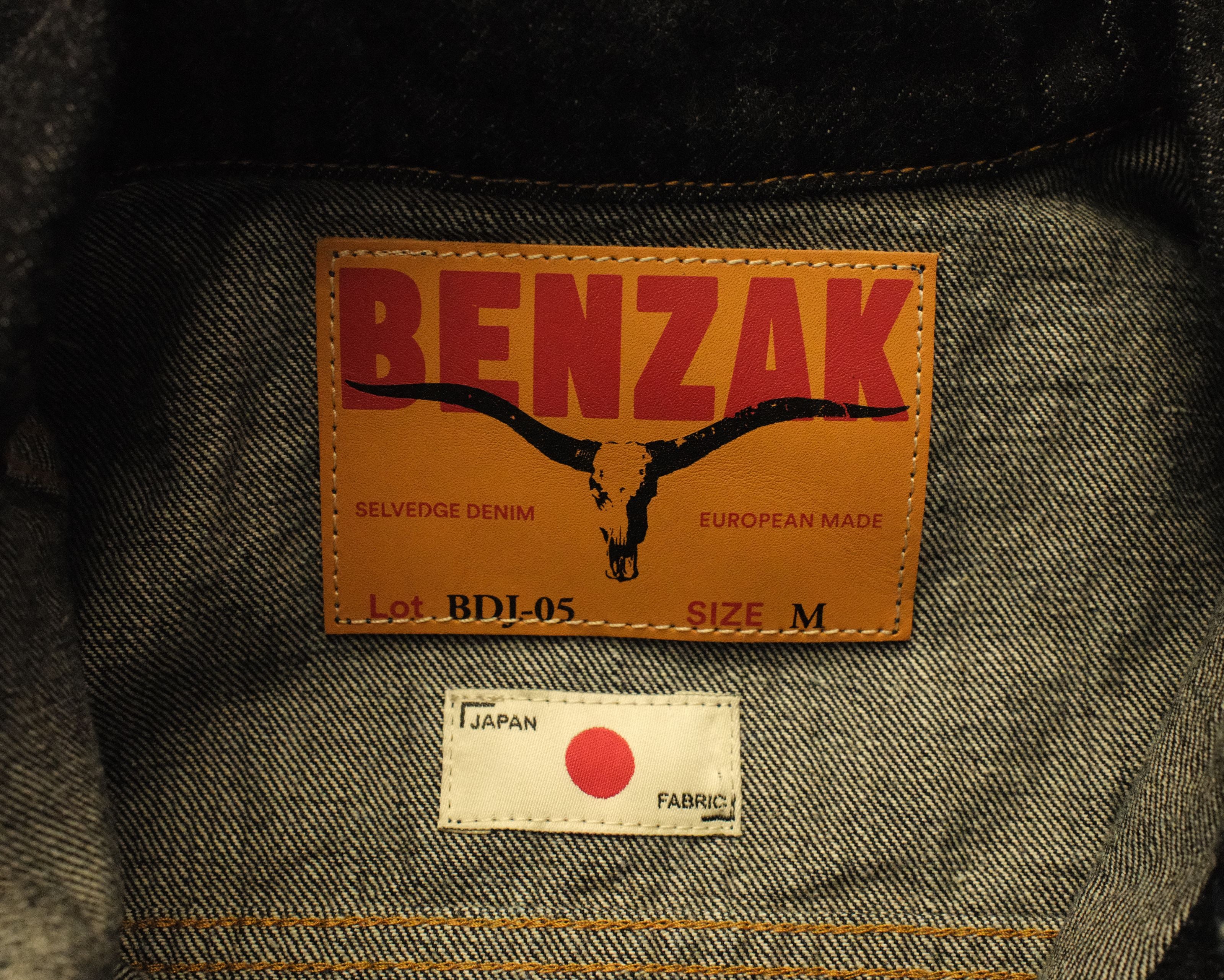Benzak denim label on a garment with a red dot in Japan fabric tag.
